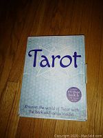 Photo of front of box showing 'Tarot' title and note about 64-page book and 78 cards inside.