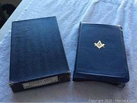 Slipcase box next to leather-bound Bible
