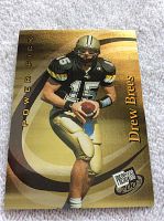 Full front view of 2001 Drew Brees rookie card showing player poised to throw football, with gold and black background and Press Pass logo.