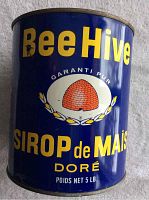 Front view of the vintage Bee Hive corn syrup can with French labeling and beehive logo.