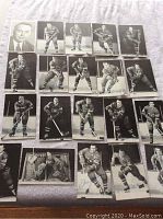 Top view of 20 black and white hockey postcards laid out on a flat surface showing Montreal Canadiens players in various poses with hockey sticks and skating gear, and one portrait photo.