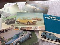 Photo of multiple Volkswagen Rabbit vintage brochures showing front covers and car images