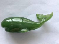 Photo of the jade whale miniature showing side profile with visible small nicks on the belly area