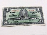 Front side of the 1937 Canadian one dollar banknote showing full note with visible serial numbers, portrait of King George VI, and bilingual text.