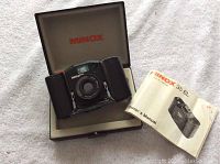 Minox 35 EL camera in open case with owner's manual.