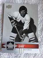Front view of black and white Bobby Orr Upper Deck hockey card showing player in stance with name and logo