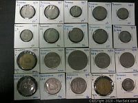 Top-down photo showing 20 coins from Panama and Dominica, each in protective holders with handwritten identification and condition grades.