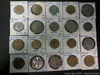 Photo showing 20 individual coins from Thailand, dated 1946 to 1987, placed in labeled holders with detailed year and condition notes.