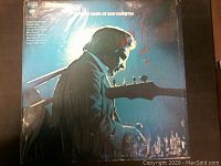Front of Johnny Cash At San Quentin LP record album cover showing Johnny Cash playing guitar with red marker writing.