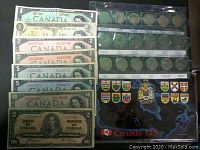 Photo showing Canadian banknotes in denominations of 1, 2, 5, and 10 dollars with some dating to 1937 and some featuring Centennial of Canadian Confederation 1867-1967 design