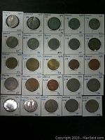 Photo of 25 modern Greek coins each in individual paper holders labeled with year, denomination, and condition mostly 1 and 2 drachma and some dec coins from 1954 to 1988.