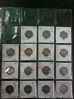 15 Canada five cent coins in individual coin holders with detailed handwritten notes about condition and varieties, organized in three rows.