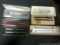 Overview of six pens in original boxes and trays