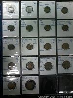 Front view showing 18 apothecary drachm weight tokens each in a labeled protective sleeve with handwritten details.