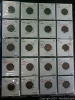 40 coins arranged in 4 rows of 10 on a flat surface, each in labeled protective holders showing various 1957 US 1 cent varieties.