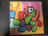 Front cover of Bruce Cockburn 'Dancing in the Dragon's Jaws' LP album, showing colorful abstract artwork and album title.