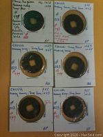 Photo of 6 ancient Chinese coins individually mounted on cardboard holders with handwritten notes showing dates between 988 and 1064 AD.