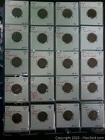 Photo shows 20 encapsulated 1 cent coins in white cardboard holders with handwritten notes describing each coin's mint mark, date, and variety. Coins are dated 1957, 1958, and 1959 with different mint marks (D, S, or none) and coin variety descriptions.