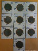 Ten Serbian WWII zinc 10 dinar coins from 1943 in individual holders with handwritten notes.