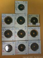 Photo showing all 10 ancient Chinese bronze coins mounted in holders with dated annotations from AD 1023 to 1126