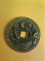 Front side of the bronze coin showing a high relief dragon design.