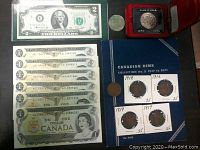 Photo showing a US $2 bill, nickel dollar coin in red case, Canadian dime collection booklet with four coins from 1916 to 1919, and two coins lying outside the booklet.