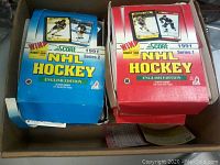 Three boxes of 1991 Score NHL Hockey cards, with visible Series 1 red box and Series 2 blue box, all in original packaging with promotional graphics.