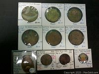 Overview of six brothel tokens in cardboard holders above four items