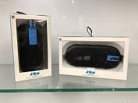 Front view of two JAM Bluetooth speakers in original packaging, showing the straps and branding clearly.