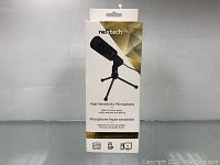 Front view of the microphone's box showing the product image and description indicating it is ideal for studio, vocals, podcasts, and gaming.