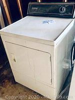 Front load Speed Queen dryer showing door with inset handle and control panel on top back edge