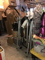 Full view of Gazelle Freestyle Crosstrainer Pro in storage among boxes and decorations.