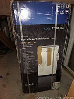 Box of Friedrich ZoneAire Portable Air Conditioner 12000 BTU showing front of box with product illustration and features.