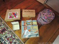 Overview of the lot showing bags, wood box, floral hat boxes, and small white box