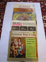 Photo showing front covers of vinyl albums including The Supremes More Hits, She Stood in the Dimension, and Christmas Sing-A-Long with family collection text.
