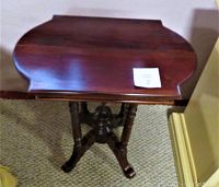 Front angle view of dark stained solid wood side table top, showing rounded edges and condition of wood surface.