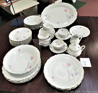 Full display of the Winterling Bavaria 26-piece china set including plates, bowls, cups, serving platters, sugar bowl, and creamer on a table