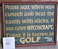 Front of the vintage wooden framed golf sign with the painted text about golf and witchcraft.