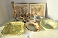Front view showing all items in lot including Nippon dish, brass vases, yellow plates, swan planter and framed plaques