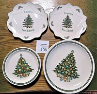 Top view showing two scalloped Christmas 'Cookies For Santa' plates and four plates with Christmas tree design, two large and two smaller.