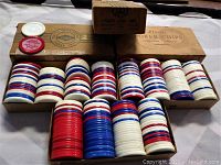 Three boxes of vintage interlocking poker chips in red, blue, white color, with packaging noted Lowe Co Inc and Plastic Poker Chips.