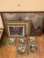 Full lot overview showing large horse painting and clustered frames and decorative plates