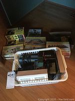 Basket with Tyco Power Pac electric power pack and wiring, with Revell model kits boxed behind