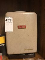 Beige Kodak Showtime projector with Kodak logo and Showtime script in gold on front.