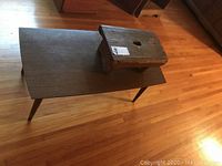 Stool placed on top of coffee table showing both items