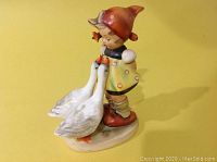Front-side view of Hummel Goose Girl figurine with two geese.