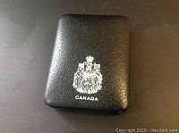 Black protective case with Canadian coat of arms and word 'CANADA' printed in white on the lid.