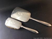 Full view of the Birks sterling silver brush and mirror set on a black background.