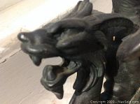 Close-up view of the lion-headed dragon face showing detailed forged cast iron design.
