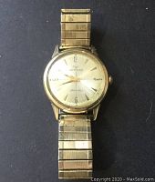 Full view of the Wittnauer wristwatch showing gold-tone metal band and round watch face.